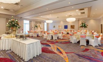 a large banquet hall filled with tables and chairs , ready for a wedding reception or other social events at DoubleTree by Hilton Atlanta Airport