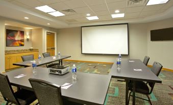 a conference room set up for a meeting , with chairs arranged in rows and a projector mounted on the wall at Residence Inn Bridgewater Branchburg