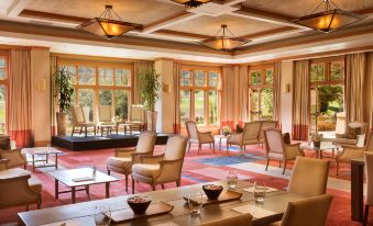 a large , well - decorated dining room with wooden floors , multiple tables , and chairs arranged for a gathering at CordeValle