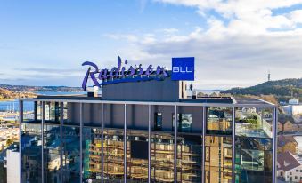 "a large building with the words "" radisson blu "" written on it , located in a city setting" at Radisson Blu Caledonien Hotel, Kristiansand