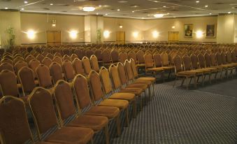 a large conference room with rows of chairs arranged in a semicircle , ready for a meeting at Best Western Plus Chicago Hillside