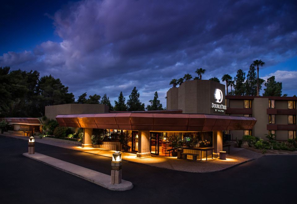 "a modern hotel building with the sign "" sheraton grand hotels & resorts "" lit up at night" at DoubleTree by Hilton Phoenix Tempe