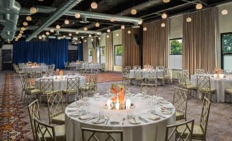 a large banquet hall with round tables and chairs set up for a formal event at Hotel Nyack, A Joie de Vivre Hotel by Hyatt