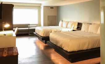 a hotel room with two beds , one on the left and one on the right side of the room at Wyndham Newport Hotel