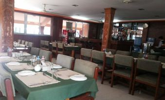 a large dining room with tables and chairs arranged for a group of people to enjoy a meal together at Hotel Westwood
