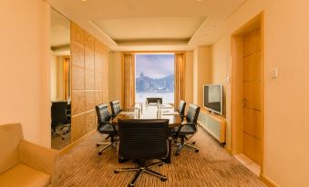 A room with large windows and an office furnished with chairs around the table in front at Harbour Plaza Metropolis