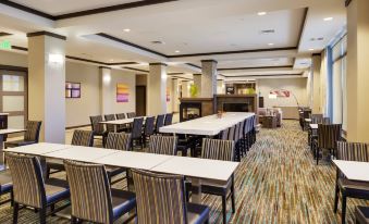a large dining room with multiple tables and chairs arranged for a group of people to sit and enjoy a meal at Residence Inn Bangor