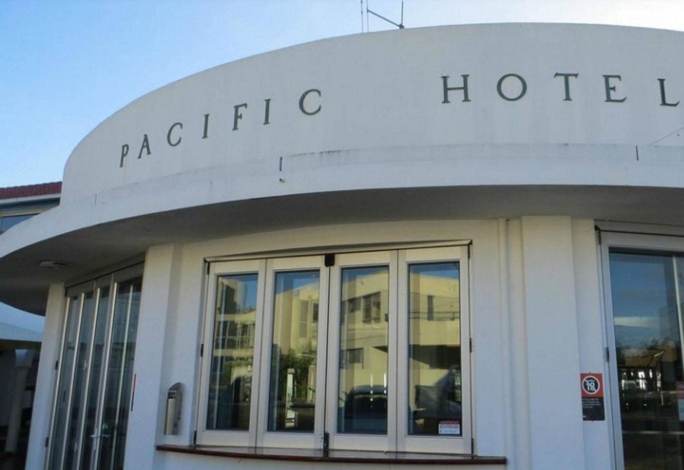 "a white building with a curved roof and the words "" pacific hotel "" written on it" at Pacific Hotel Yamba