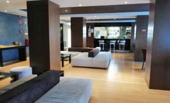 a modern , well - lit living room with wooden floors and white furniture , including sofas and tables at Hotel Monaco