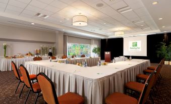 a conference room with a large table and chairs , set up for a meeting or event at Holiday Inn Laval - Montreal