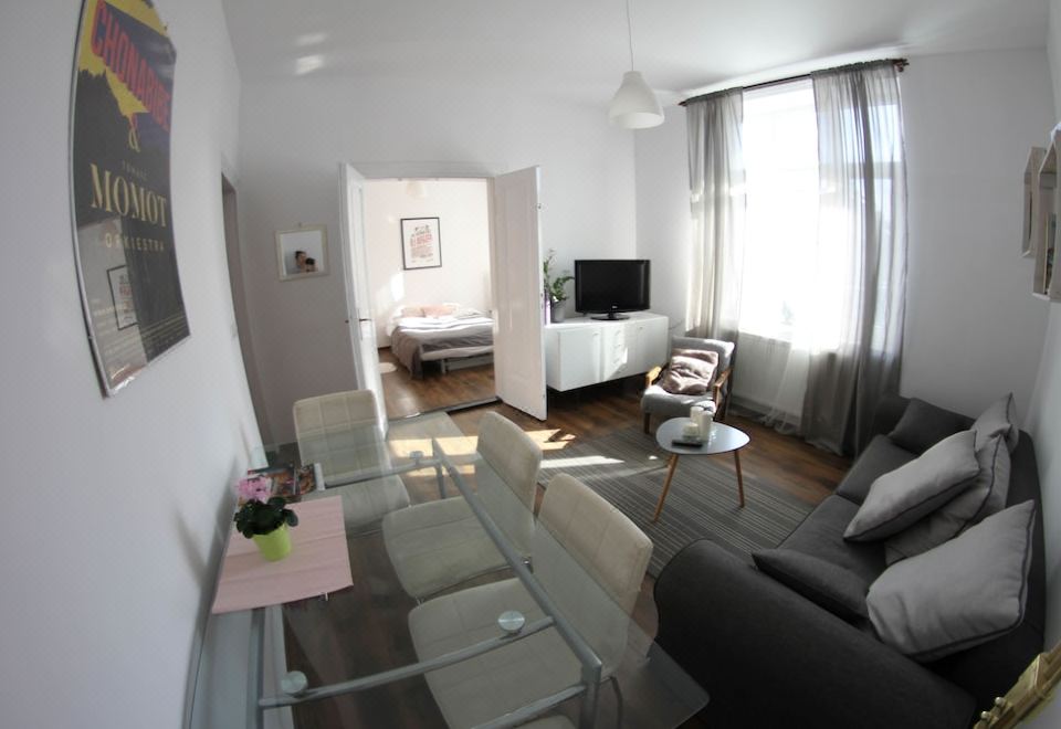 a modern living room with a couch , coffee table , and television is shown in this image at Downtown Apartments