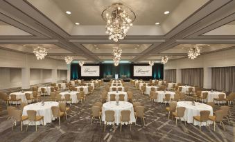 a large banquet hall with tables and chairs set up for a formal event , possibly a wedding reception at Fairmont Dallas