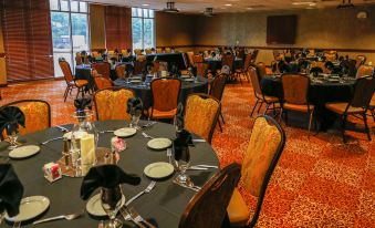 a large conference room with multiple tables and chairs arranged for a meeting or event at Honey Creek Resort