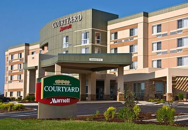 the courtyard by marriott hotel , with its sign in the foreground and an entrance to the building below at Courtyard Columbus New Albany