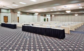 a large conference room with multiple tables and chairs , all facing the same direction , set up for a meeting or event at Holiday Inn Express Big Rapids