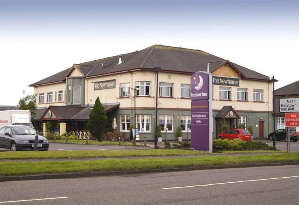 the weymouth hotel , a large white building with a purple sign and a street in front at Premier Inn Glasgow (Motherwell)