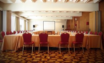 a conference room set up for a meeting , with chairs arranged in a semicircle around a long table at Arribas Sintra Hotel