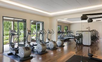 a well - equipped gym with various exercise equipment , such as treadmills , stationary bikes , and weight machines at Rosewood Sand Hill