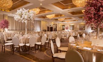 a large banquet hall with multiple tables and chairs set up for a formal event , possibly a wedding reception at The Heritage