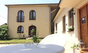 a white table and chairs are set up in front of a house with a brown building at Ferienhaus