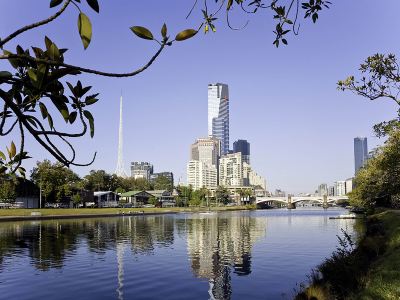 a city skyline with a river in the foreground and tall buildings in the background at Ibis Melbourne Hotel and Apartments