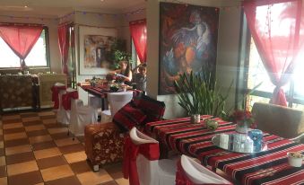 a dining room with tables and chairs arranged for a group of people to enjoy a meal together at Logan City Motor Inn