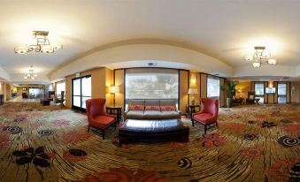 a modern , well - lit hotel lobby with comfortable seating and a large window offering views of the outdoors at Holiday Inn Dublin - Pleasanton, an IHG Hotel