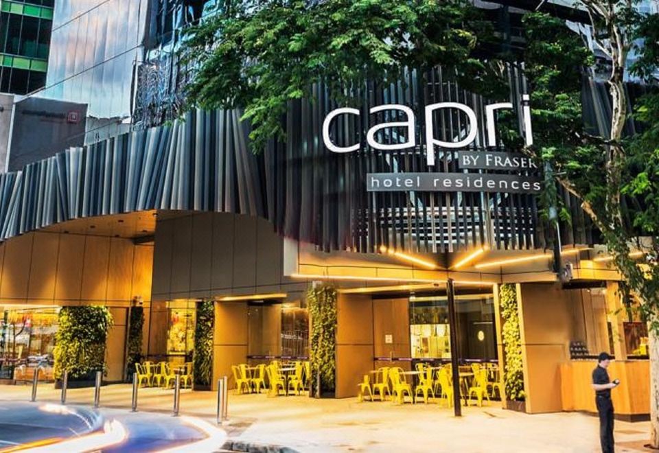 "a modern building with a large sign that reads "" capri hotel residences "" prominently displayed on the front of the building" at Capri by Fraser Brisbane