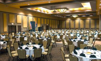 a large banquet hall filled with round tables and chairs , ready for a formal event at Desert Diamond Casino