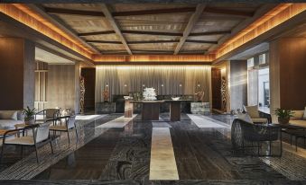 a spacious , well - lit room with wooden ceiling and walls , featuring a large reception desk and multiple potted plants at Four Seasons Resort and Residence Anguilla