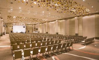 a large , empty conference room with rows of chairs and a stage at the front at Sun Gardens Dubrovnik