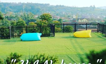 a grassy field with two large inflatable couches , possibly bean bags , placed on the grass at Van House