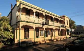 a three - story building with a green roof and balconies is shown in the image at Seaview House