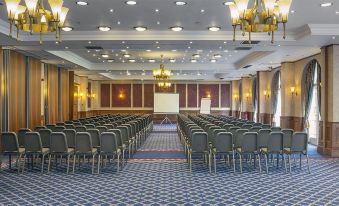 a large conference room with rows of chairs arranged in a semicircle , ready for an event at Quorn Country Hotel