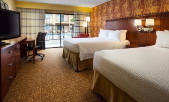 a hotel room with two beds , one on the left side and the other on the right side of the room at Courtyard Pleasanton