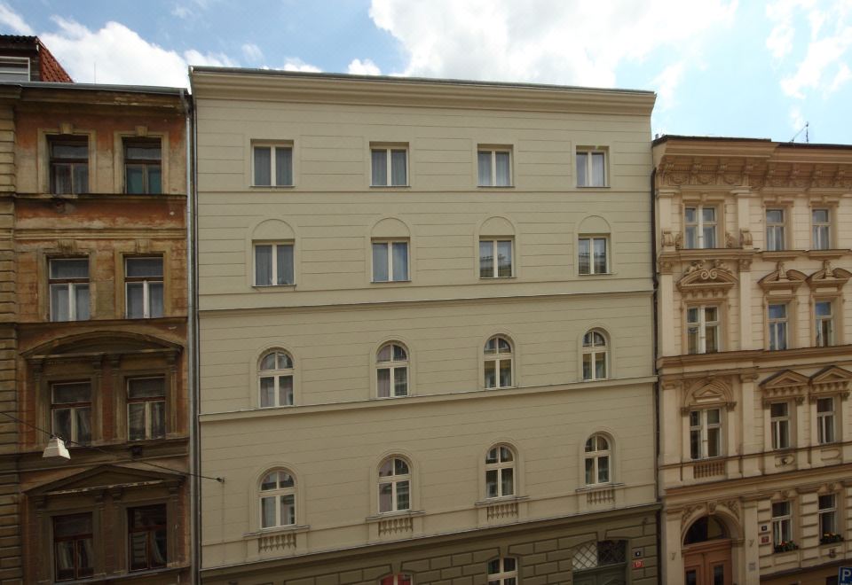 a tall building with many windows is surrounded by other buildings in an urban setting at Pure White