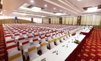 a large conference room with rows of chairs arranged in a semicircle , and a podium at the front at Muong Thanh Grand Quang Nam