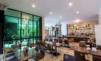 a large dining room with tables and chairs arranged for a group of people to enjoy a meal together at Soho Boutique Hotel