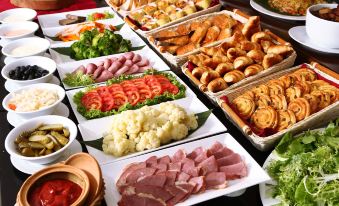 a buffet table filled with a variety of food items , including meat , vegetables , and breads at Super Hotel Candle