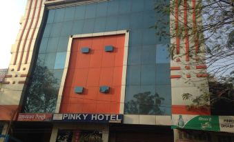 "a modern building with a large glass facade and the words "" pinky hotel "" written in red" at Pinky Hotel