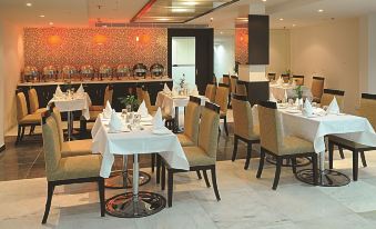 a well - decorated dining room with tables and chairs arranged for a large group of people at Amara Hotel