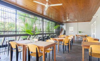 a dining room with wooden tables and chairs arranged for a group of people to enjoy a meal together at Motel Nomad