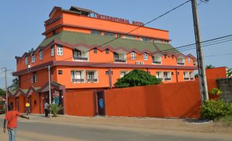 "a large orange building with a green roof and the words "" millenium hotel "" written on it" at Hotel International