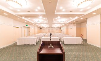 a large conference room with rows of tables and chairs arranged for a meeting or event at Sun Palace Hotel