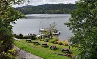 a large body of water , possibly a lake , with a dock and several boats docked nearby at Beech Hill Hotel & Spa