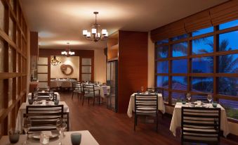 a dining room with several tables and chairs arranged for a group of people to enjoy a meal at Hyatt Regency Kuantan Resort