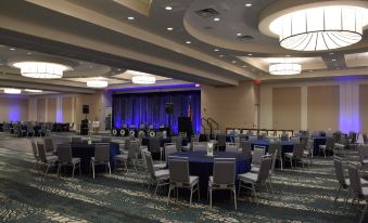 a large banquet hall with multiple tables and chairs , all set up for an event at Holiday Inn Cincinnati N - West Chester
