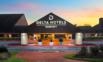 the delta hotels marriott hotel is shown with a brick walkway and potted plants in front at Delta Hotels by Marriott Baltimore Hunt Valley