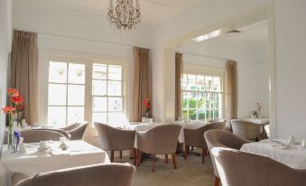 a dining room with several tables and chairs arranged for a group of people to enjoy a meal together at Brooklands of Mornington