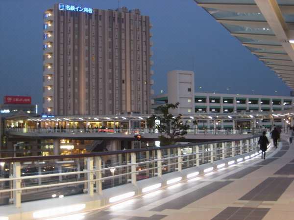 a city scene at night , with a tall building and a bridge in the background at Meitetsu Inn Kariya